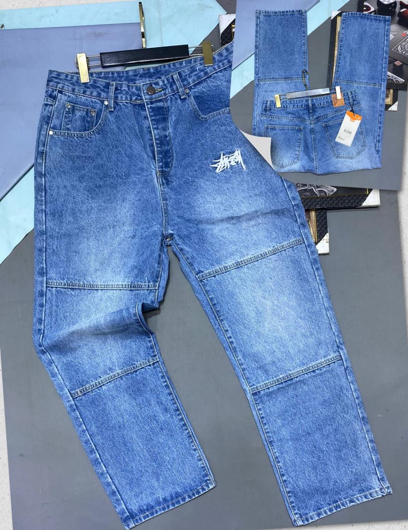 Classic Blue Relaxed Jeans with Horizontal Mid-Thigh Seams and White Graffiti Branding