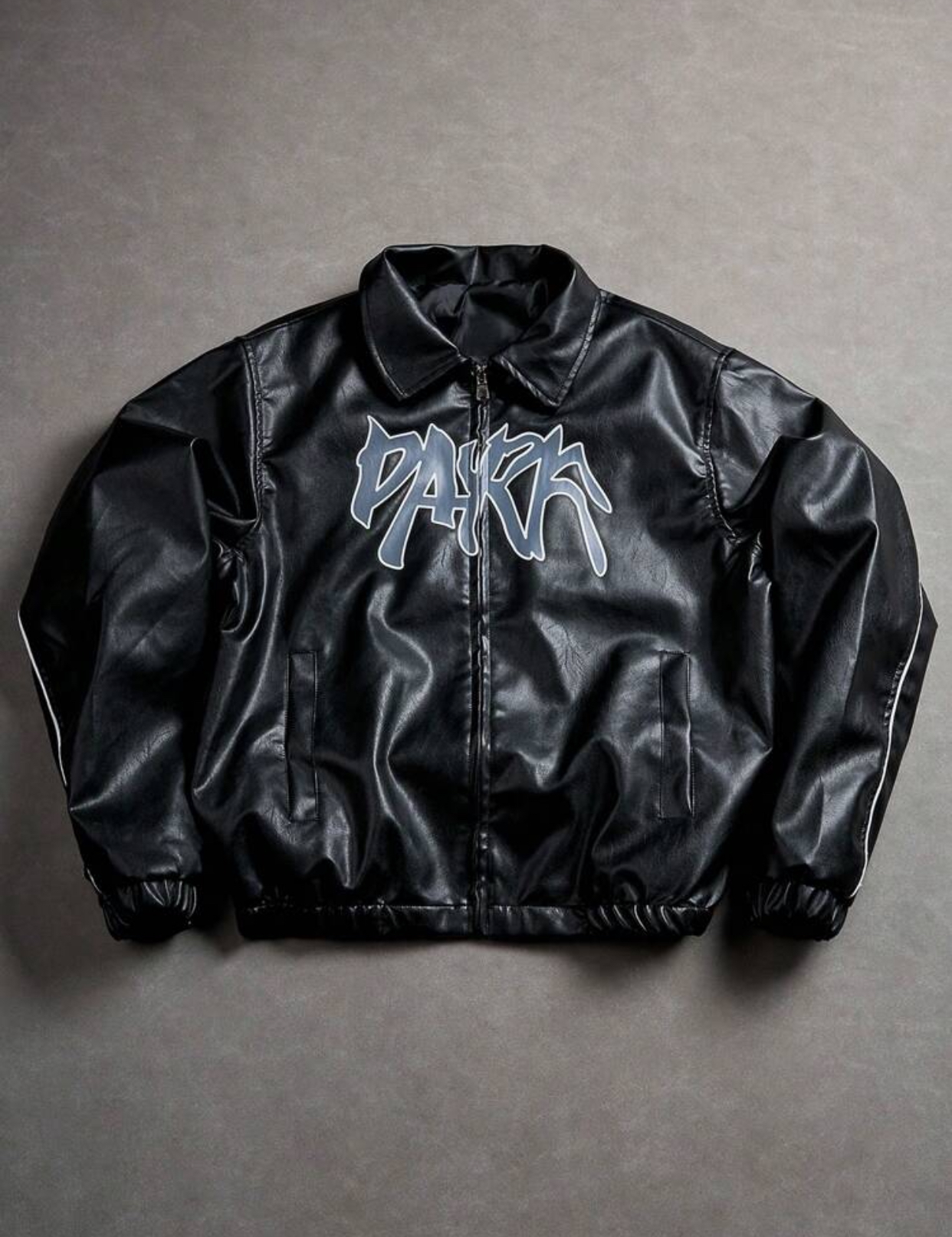 Contemporary Cream-Ivory Supple Faux-Leather Turn-Down Collar Streetwear Blouson Bomber Jacket Configured with Dual Front Slit Welt Pockets, Silver Zipper Hardware, and a Central Abstract Dark Slate Grey-Blue Graffiti "PARK" Bubble Script Graphic 3
