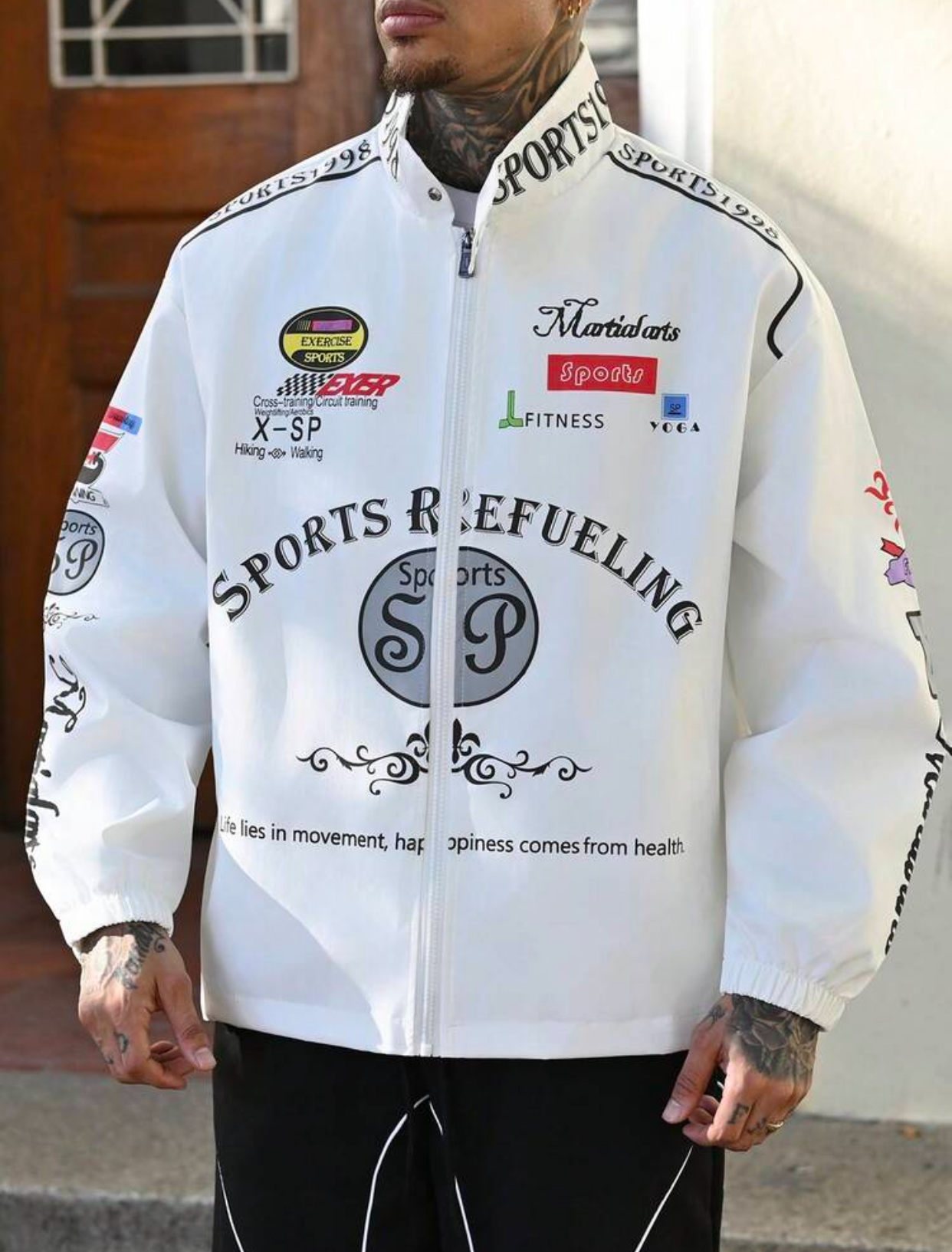 Retro Motorsport-Inspired White Windbreaker Racing Jacket Heavily Embellished with Multicolored Athletic Graphic Badges, High-Neck "SPORTS" Collar, and Large Curving "SPORTS REFUELING" Chest Typography