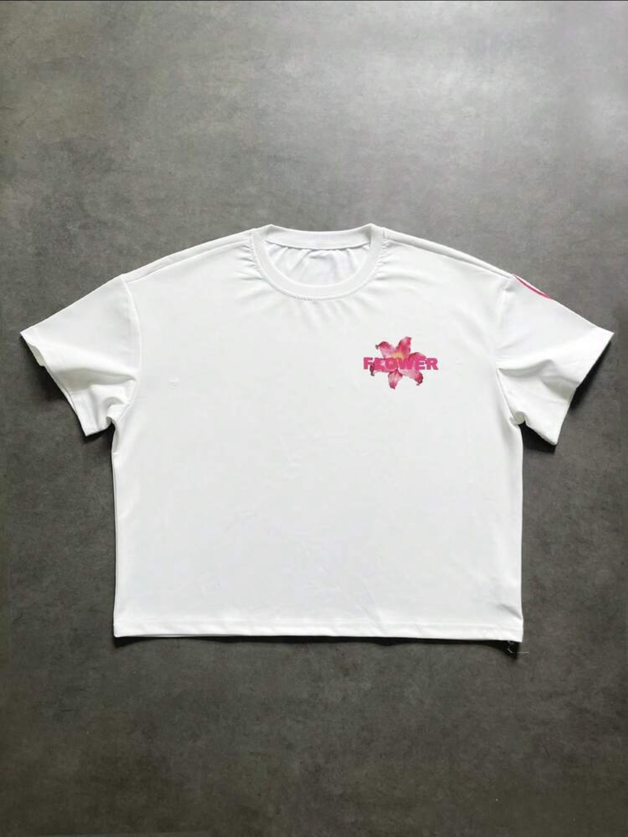 Minimalist Boxy Cropped Off-White Streetwear T-Shirt Embellished with a Vibrant Pink Lily Graphic and Layered "FLOWER" Sans-Serif Chest Typography
