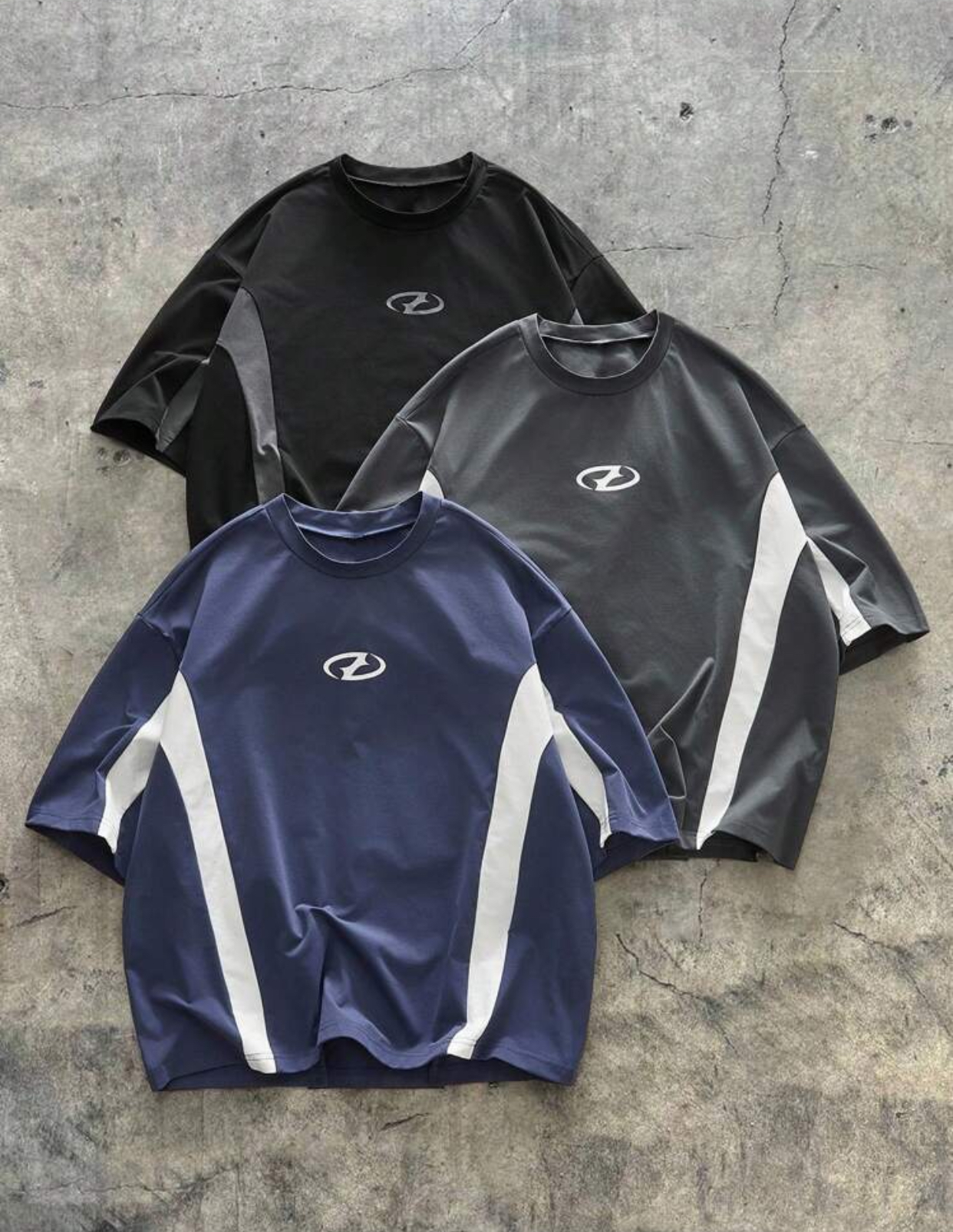 Y2K Cyber-Sportswear Heavyweight Panelled T-Shirt Capsule Collection in Navy Blue, Charcoal Grey, and Jet Black Featuring Aggressive Angular Side Strips and a Centered Minimalist Oval Cyber Emblem