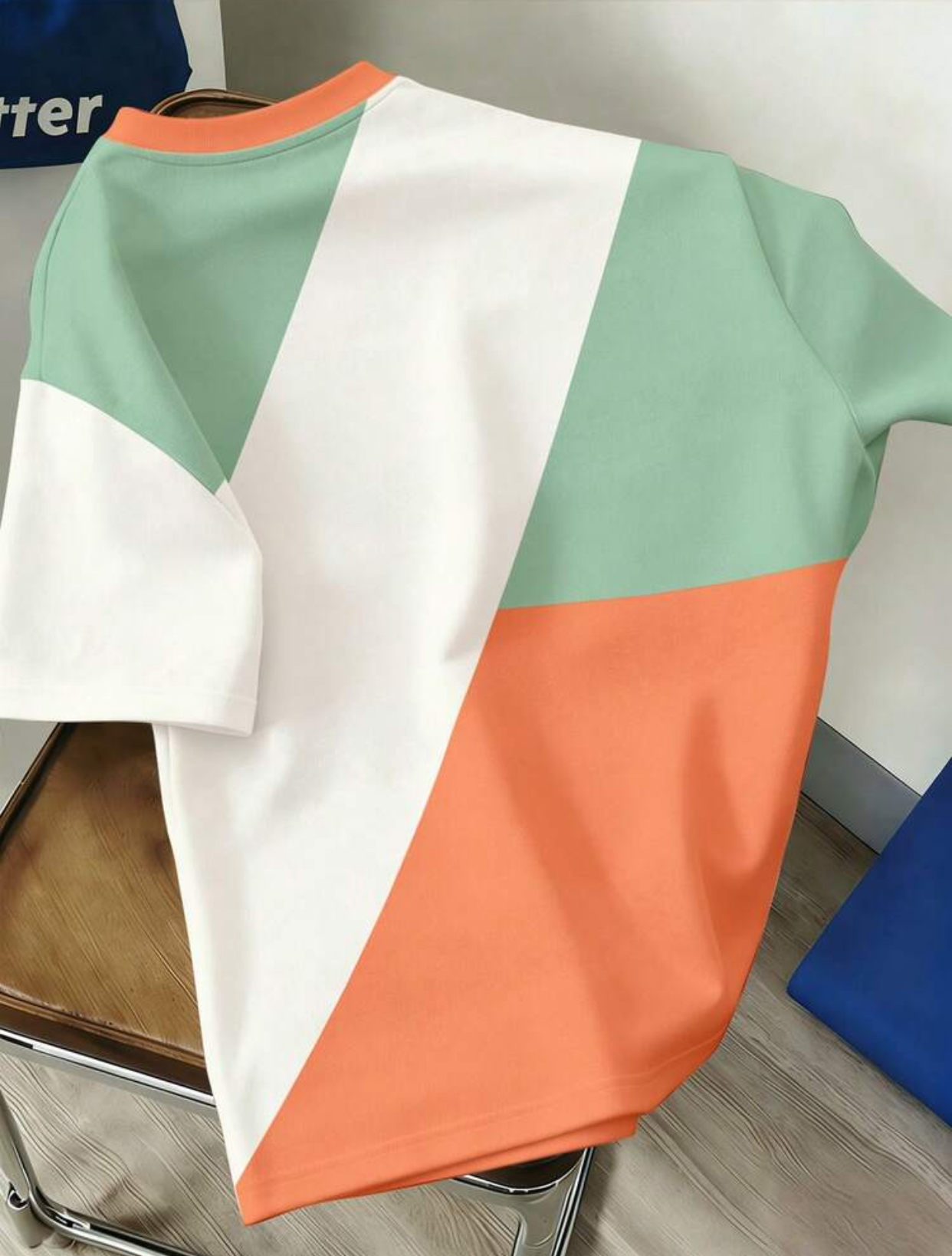 Retro 90s Geometric Color-Blocked Boxy T-Shirt Featuring Asymmetric Diagonal Panels of Soft Sage Green, Vibrant Pastel Orange, and Crisp White with a Coordinating Orange Ribbed Collar