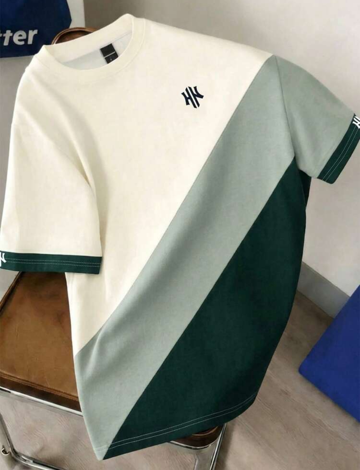 Retro 90s Geometric Color-Blocked Boxy T-Shirt Featuring Asymmetric Diagonal Panels of Soft Sage Green, Vibrant Pastel Orange, and Crisp White with a Coordinating Orange Ribbed Collar 2