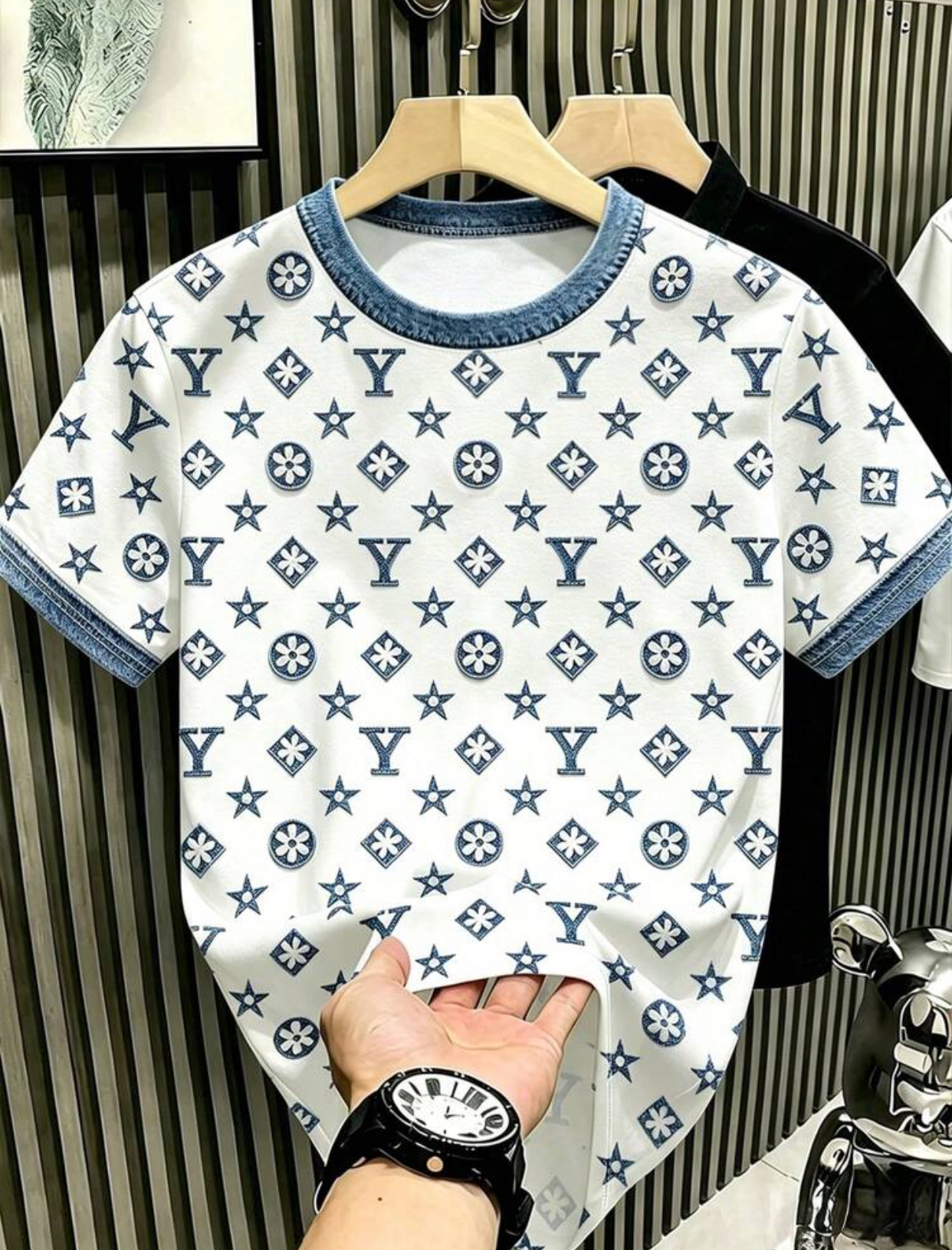 Luxury Streetwear White T-Shirt Featuring an All-Over Indigo Monogram Print of Geometric Florals, Stars, and Stylized "Y" Lettering Completed with Indigo Denim Ribbed Knit Collar and Cuff Trims