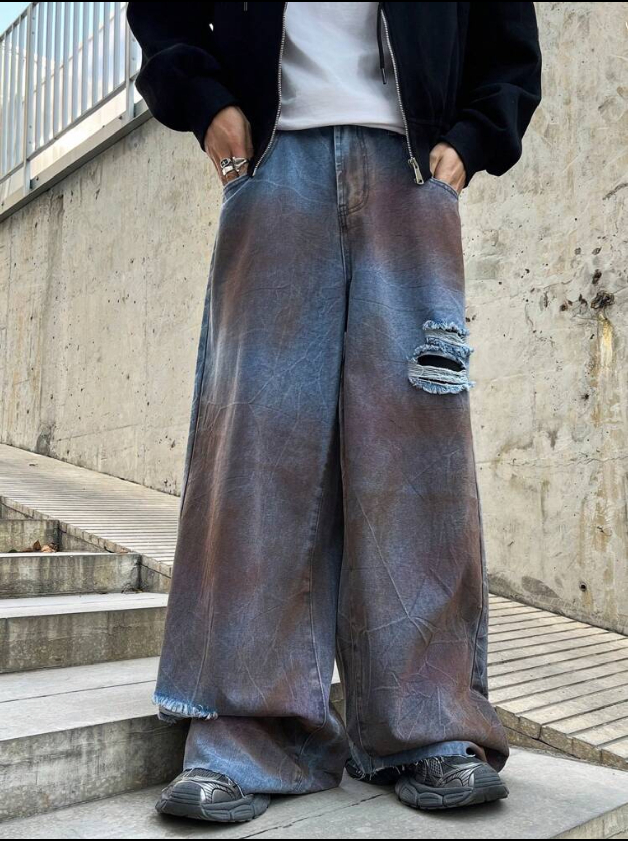 Avant-Garde Post-Apocalyptic Mud-Washed Ultra-Baggy Denim Jeans Featuring Heavy Rust-Toned Over-Dye Crinkle Textures and a Shredded Left-Thigh Distressed Slash