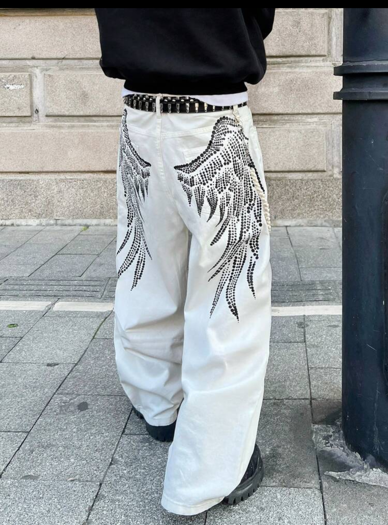 Y2K Gothic-Revival Baggy Off-White Denim Trousers Detailed with Large Back-Pocket Black Rhinestone Fallen Angel Wing Graphics and a Studded Leather Belt 3