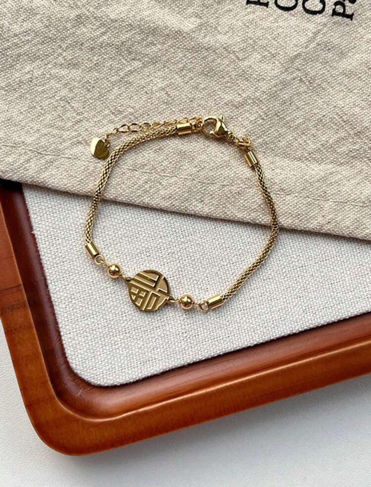 Traditional Meets Modern 14k Gold-Plated Stainless Steel Fine Mesh Chain Bracelet Featuring a Centered Open-Work Geometric Circular "Fu" Good Fortune Character Charm Pendant